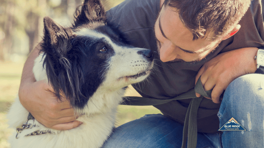 Man hugging his dog.